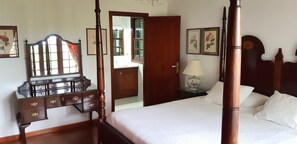 A four-poster bed with a wooden headboard, a nightstand with a lamp, a dresser with drawers, and a mirror on the wall. - Beautiful villa/farmhouse in exclusive 5,000m2 botanical garden, private pool (La Orotava)