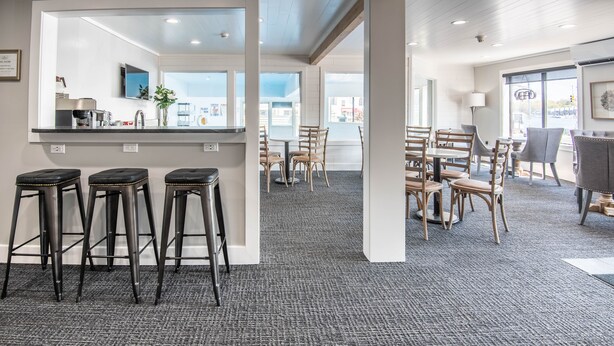 A modern interior with a bar area, seating, and a view of the outside.