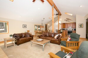 Relax in this stylish living area with a leather sofa, coffee table, and armchair.