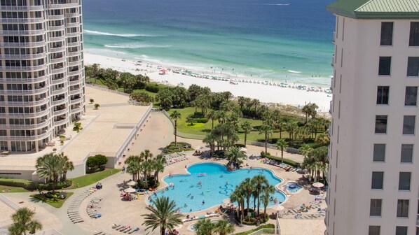 A resort with a pool, beach, and ocean view. - Luxury 3BR Beachfront Condo at Silver Shells! Tropical Pool, Hot Tub, Balcony (Destin)