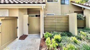 A residential building with a tiled roof, a gated entrance, and a number 5197. - Fresh updates with Golf Cart! 5197 BW (Miramar Beach)
