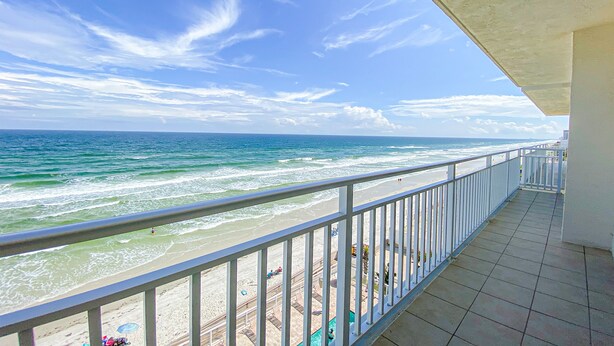 Ein Balkon mit Blick auf Strand und Meer.