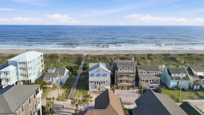 A coastal residential area with houses, a beach, and the ocean.