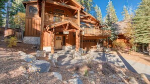 A wooden lodge with a balcony, stone steps, and a sign indicating the number 500. - Olive 4 BR Private Hot Tub, Fenced Yard, Pet-Friendly, Walk to Lake (Carnelian Bay)