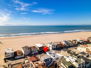 A coastal town with a beach, houses, and a red arrow pointing to a specific location. - 3612O Hollywood Beach Inboard home Pet Friendly! (Oxnard)
