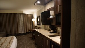 A hotel room with a bed, a desk with a sink, a coffee maker, and a television. - Prime Ski Week at Snowbird's Cliff Club Sleeps 6 in 1bedroom (Sandy)