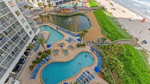 A hotel with multiple swimming pools, a beach, and a view of the ocean. - Family fun with amazing amenities + Free Attraction Tickets! (Myrtle Beach)