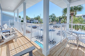 Relax in a tranquil outdoor space with lounge chairs and a pool view.
