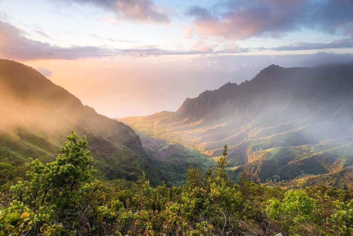 A mountainous landscape with lush greenery and a valley.