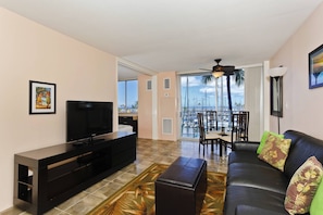 Relax in this stylish living room with a flat-screen TV, comfortable sofa, and beautiful marina views.