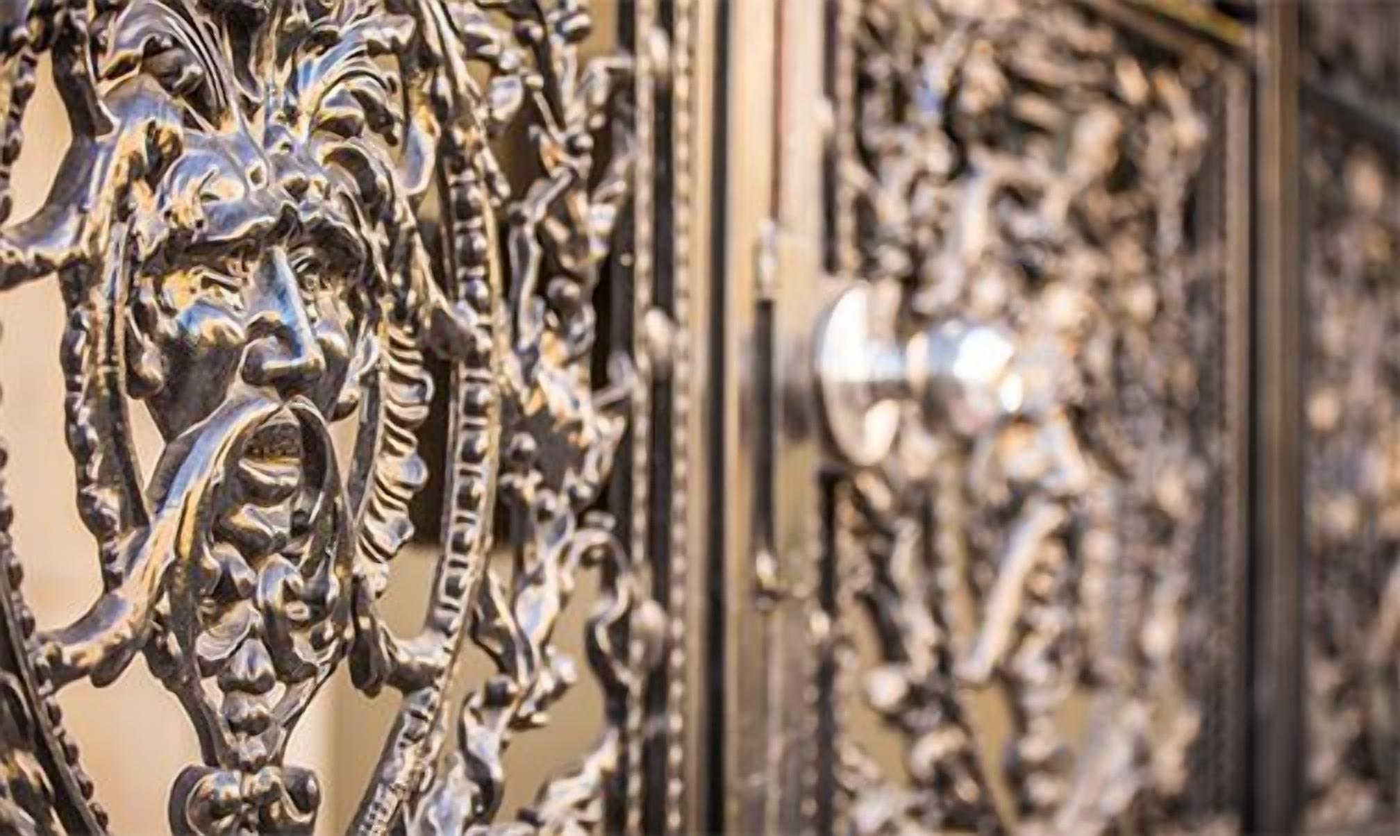 A close-up of an ornate metal gate with intricate designs.