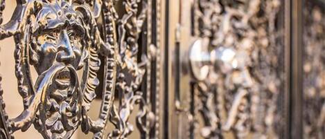 A close-up of an ornate metal gate with intricate designs.