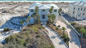 A beachfront property with a central building, a secondary building, and a paved walkway. - Kiva Grand by GSVR | Spectacular Beachfront Family Retreat w/ Pool & Hot Tub + FREE Activities/Golf (Gulf Shores)