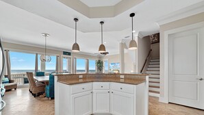 A spacious kitchen with white cabinetry, a granite countertop, and pendant lighting. - Lone Palm by GSVR | Charming Beachfront Retreat w/ Great Primary Bed/Bath + FREE Activities/Golf (Gulf Shores)