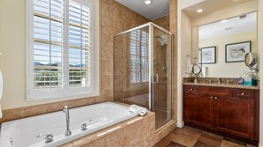 Bathtub, hair dryer, towels, shampoo