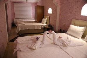 A hotel room with two beds, a window, and a radiator. - Nil Story House (Nevsehir)
