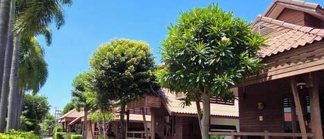 A row of wooden buildings with a clear blue sky above.