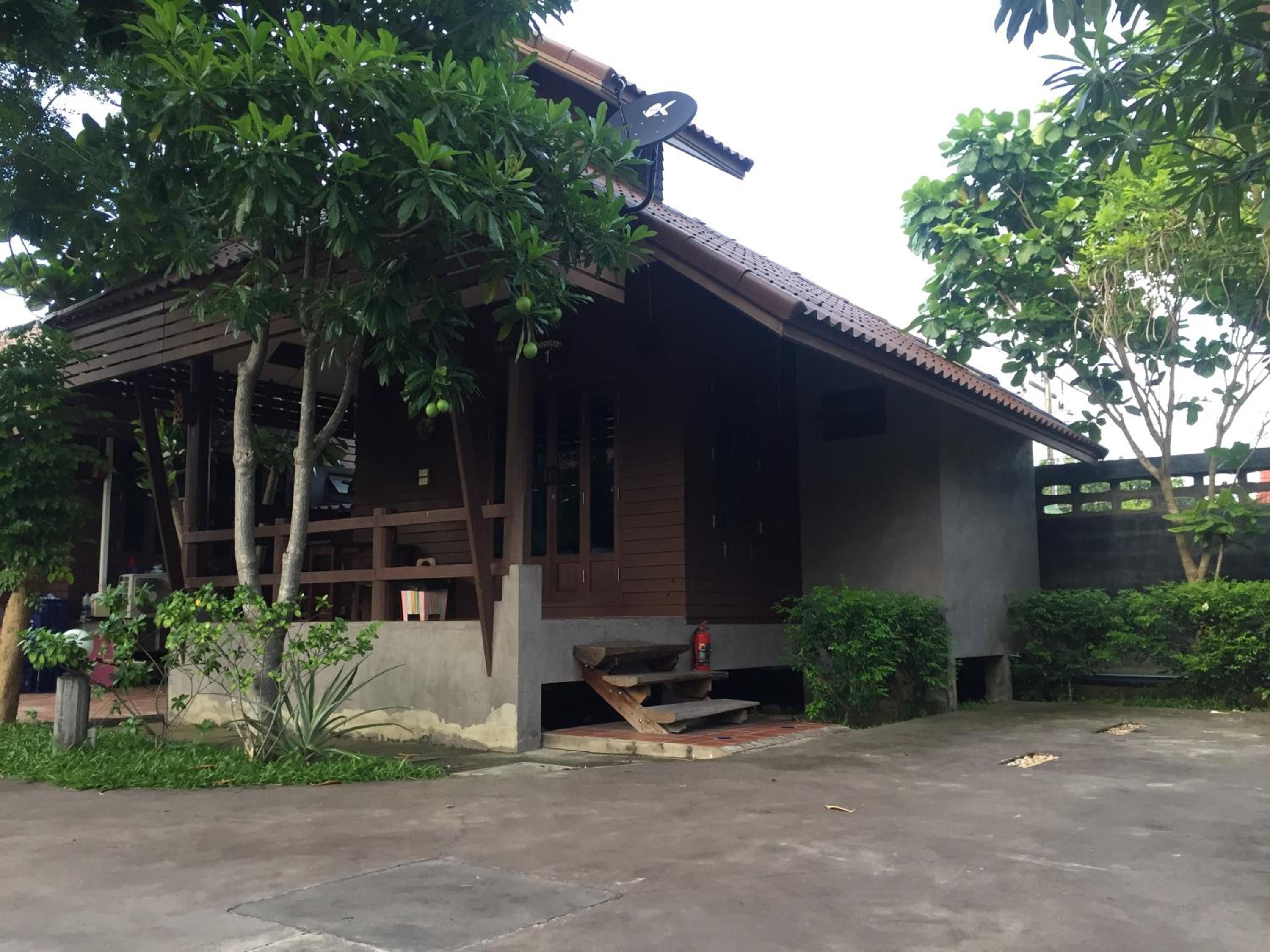 A building with a sloped roof, wooden beams, and a satellite dish.