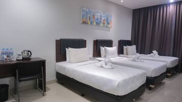 A hotel room with two beds, a desk, a chair, a painting on the wall, and a curtain.