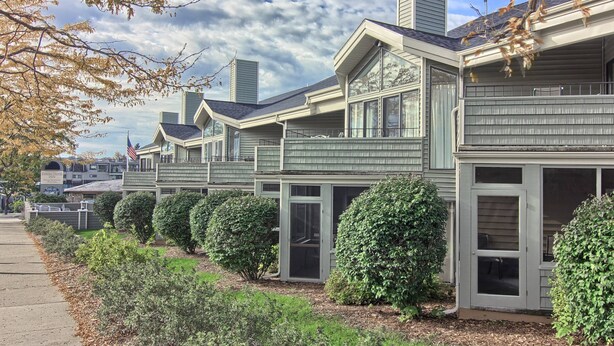 A row of modern, two-story houses with large windows and a well-maintained garden.