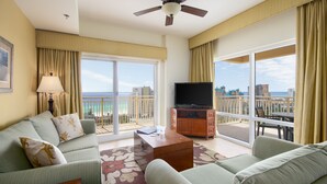 A hotel room with a balcony, a television, and a sofa. - Lockout Style ~ Gulf Views ~ Balcony ~ Resort Pool (Miramar Beach)