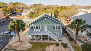 A two-story building with a green roof and a balcony with white railings. - 2 story, 2nd Row House w/private pool & hot tub + Free Attraction Tickets! (North Myrtle Beach)