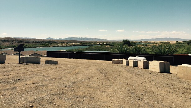 A rooftop with a view of a lake and mountains.