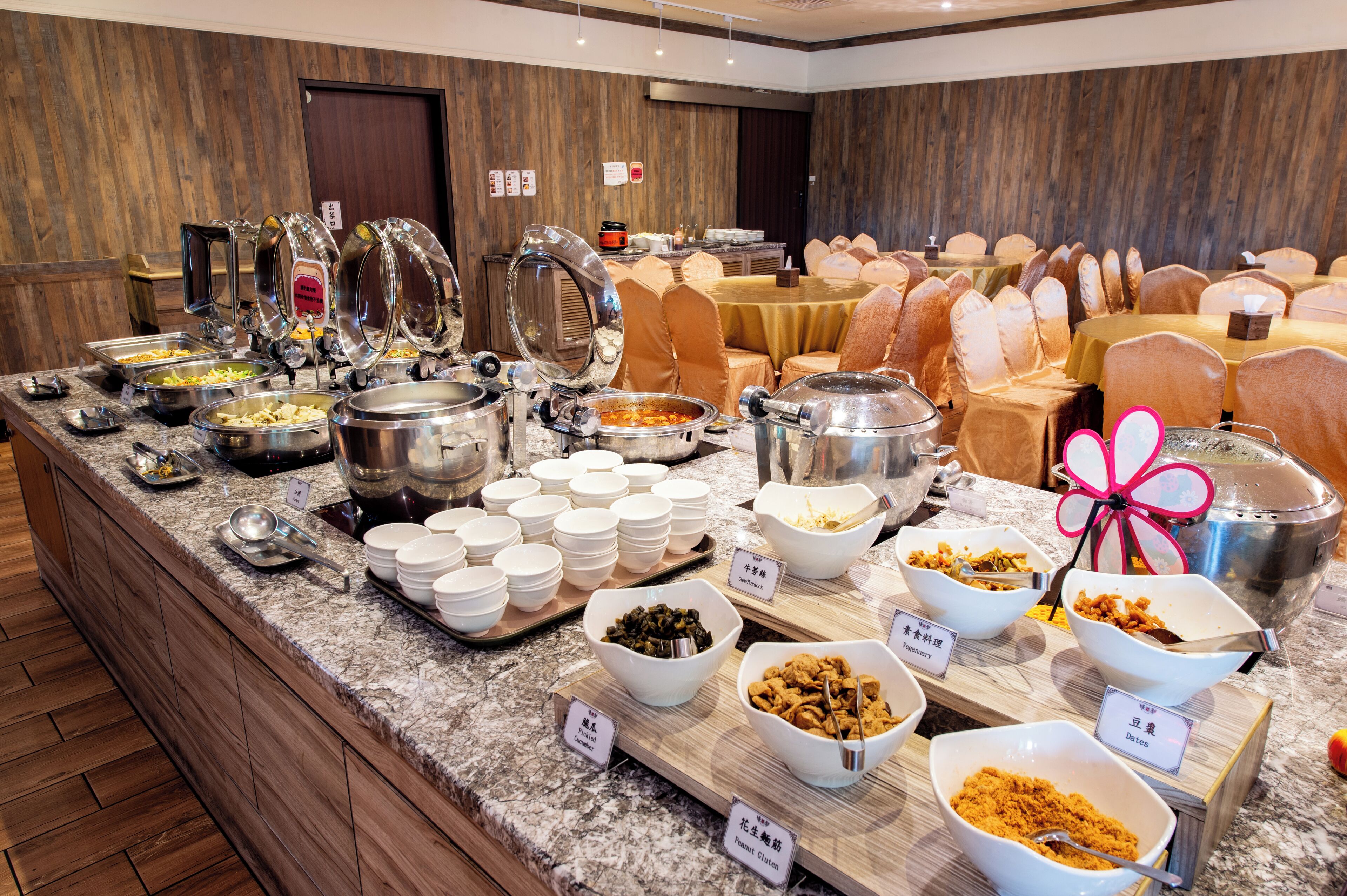 A buffet with various food stations and seating arrangements.