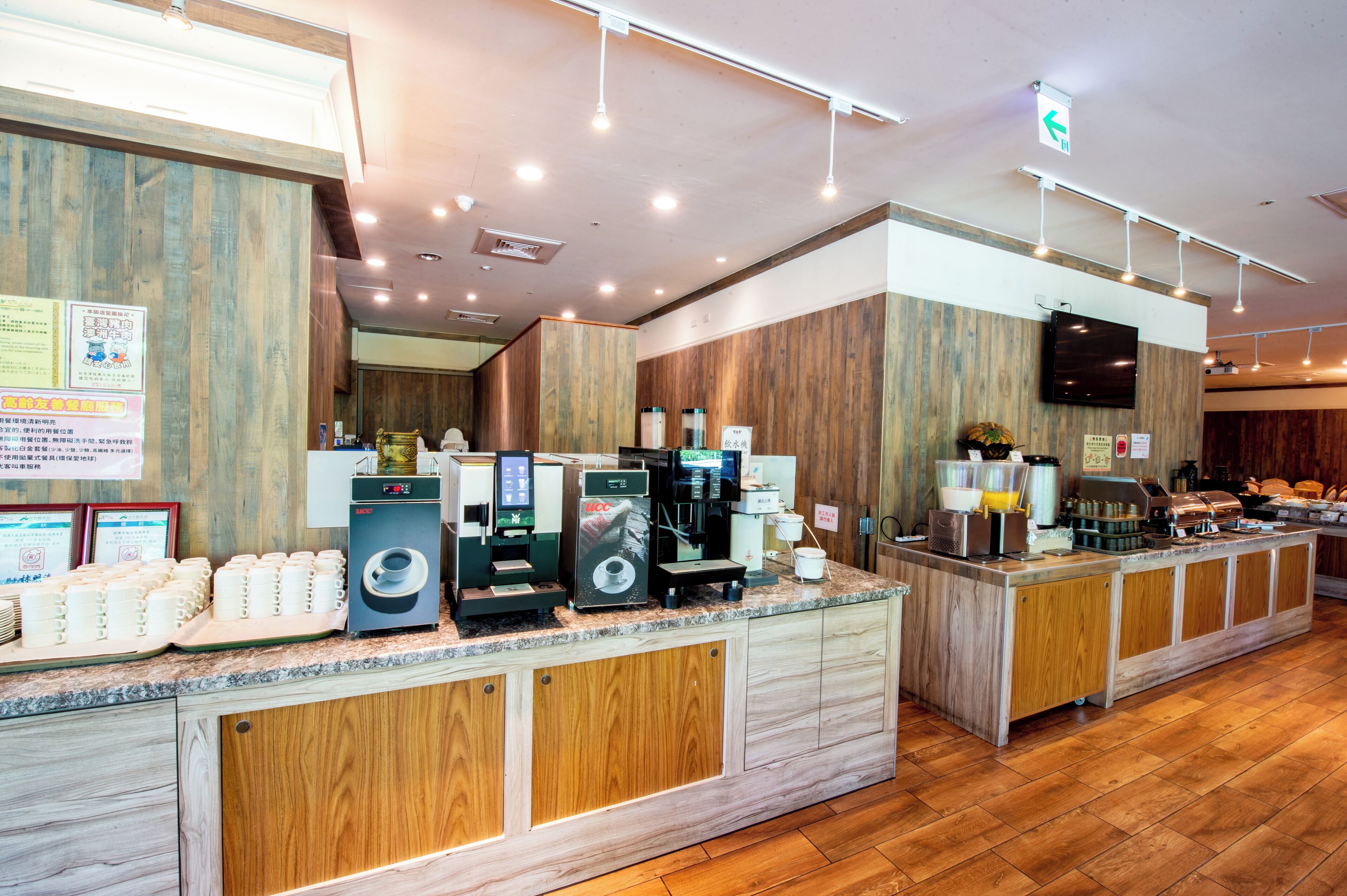 A coffee station with multiple coffee machines and a variety of coffee cups.