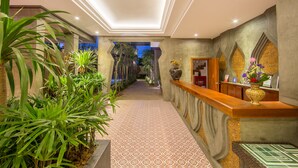 A reception area with a patterned floor, a reception desk, and a view of the outdoors. - Golden Temple Villa (Siem Reap)