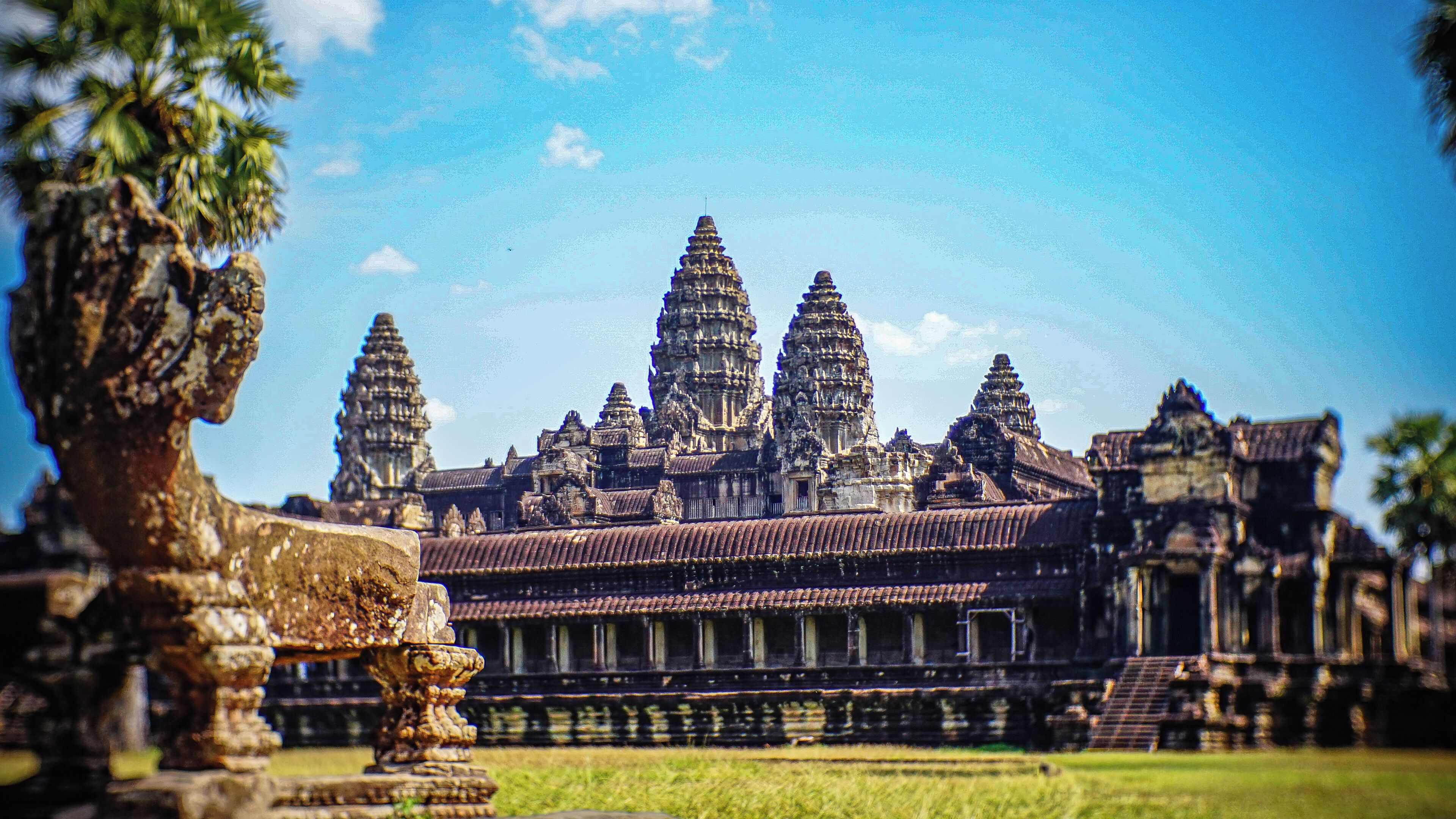 A large, historic temple complex with multiple tiered towers and intricate stone carvings.