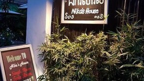 A sign for Nikā's House with a welcoming message and a contact number. - Nika's House (Siem Reap)