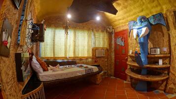 A room with a bed, a window with curtains, a red door, and a shelf with a blue fish decoration.