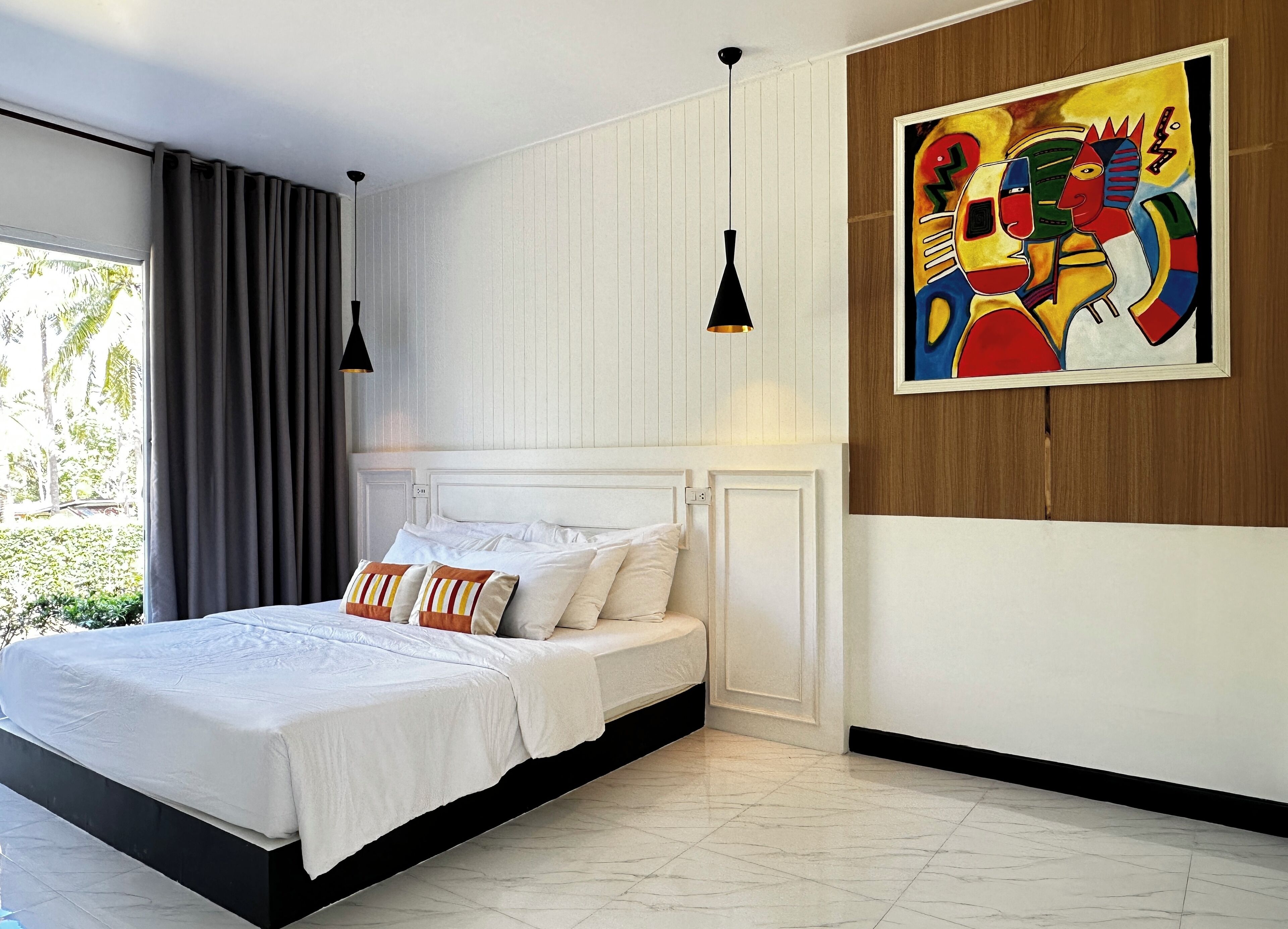 A modern bedroom with a large bed, white bedding, and a colorful abstract painting on the wall.