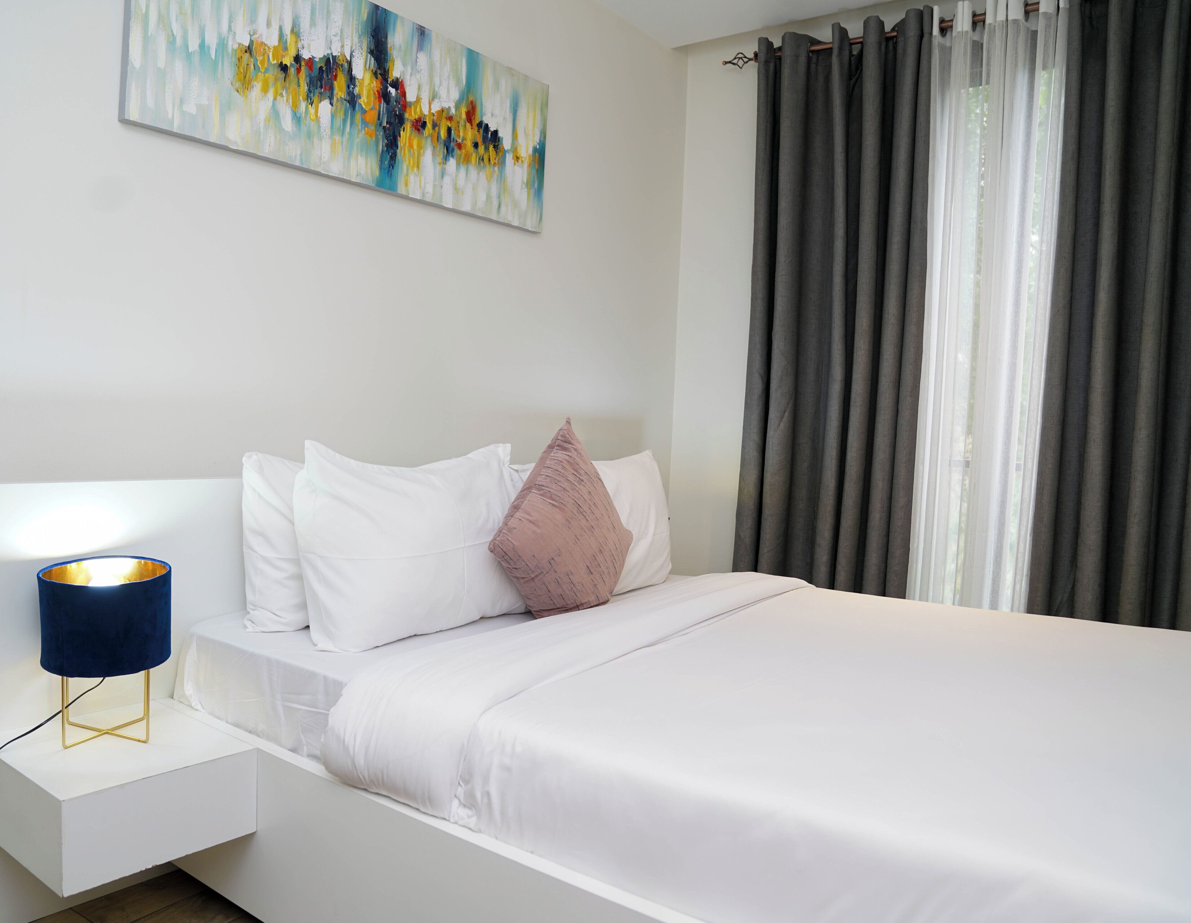 Premium bedding, desk, laptop workspace, soundproofing