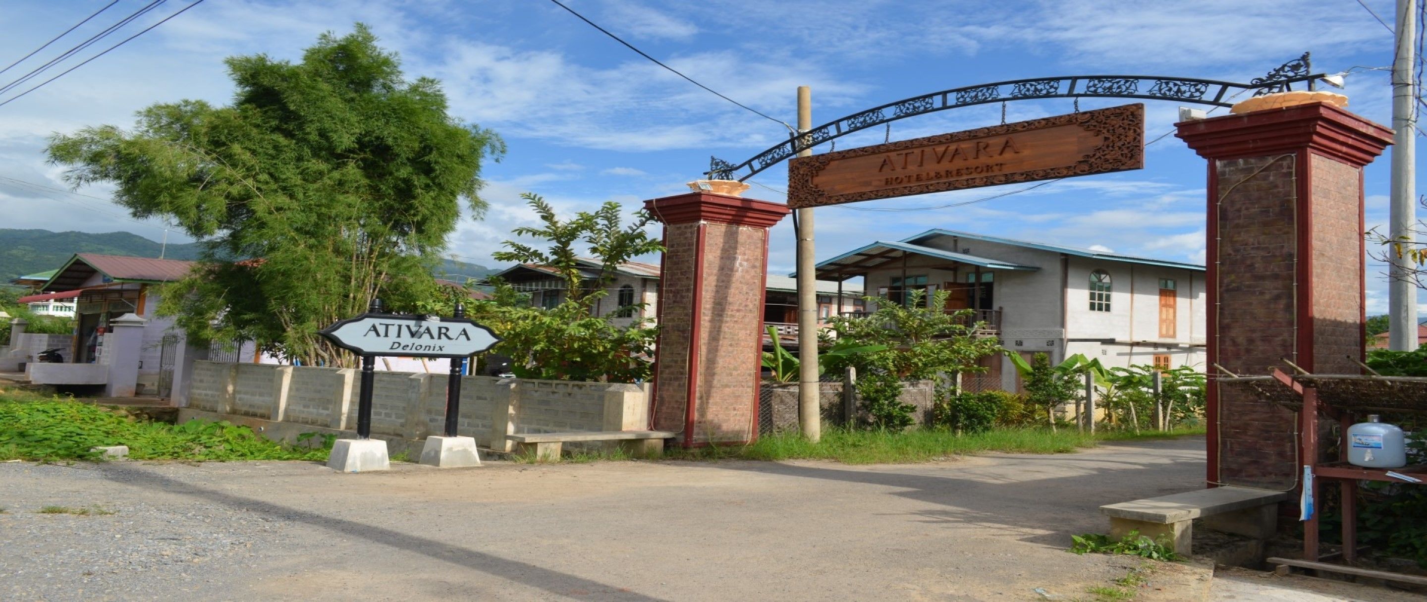 A hotel entrance with a sign reading "Ativara Hotel & Resort" and "Ativara Delonix".