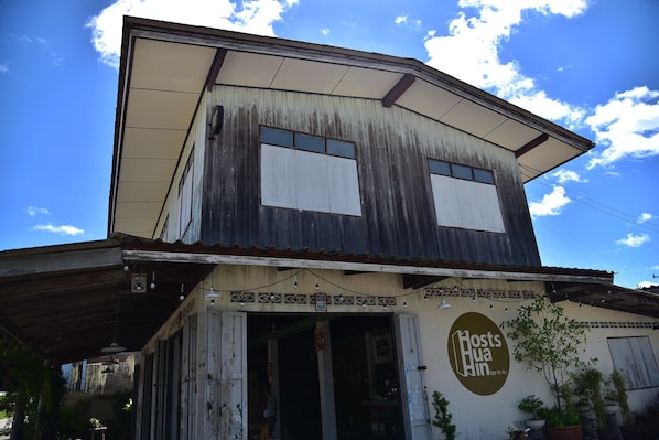 An old building with a sign reading "Host's Hua Hin."