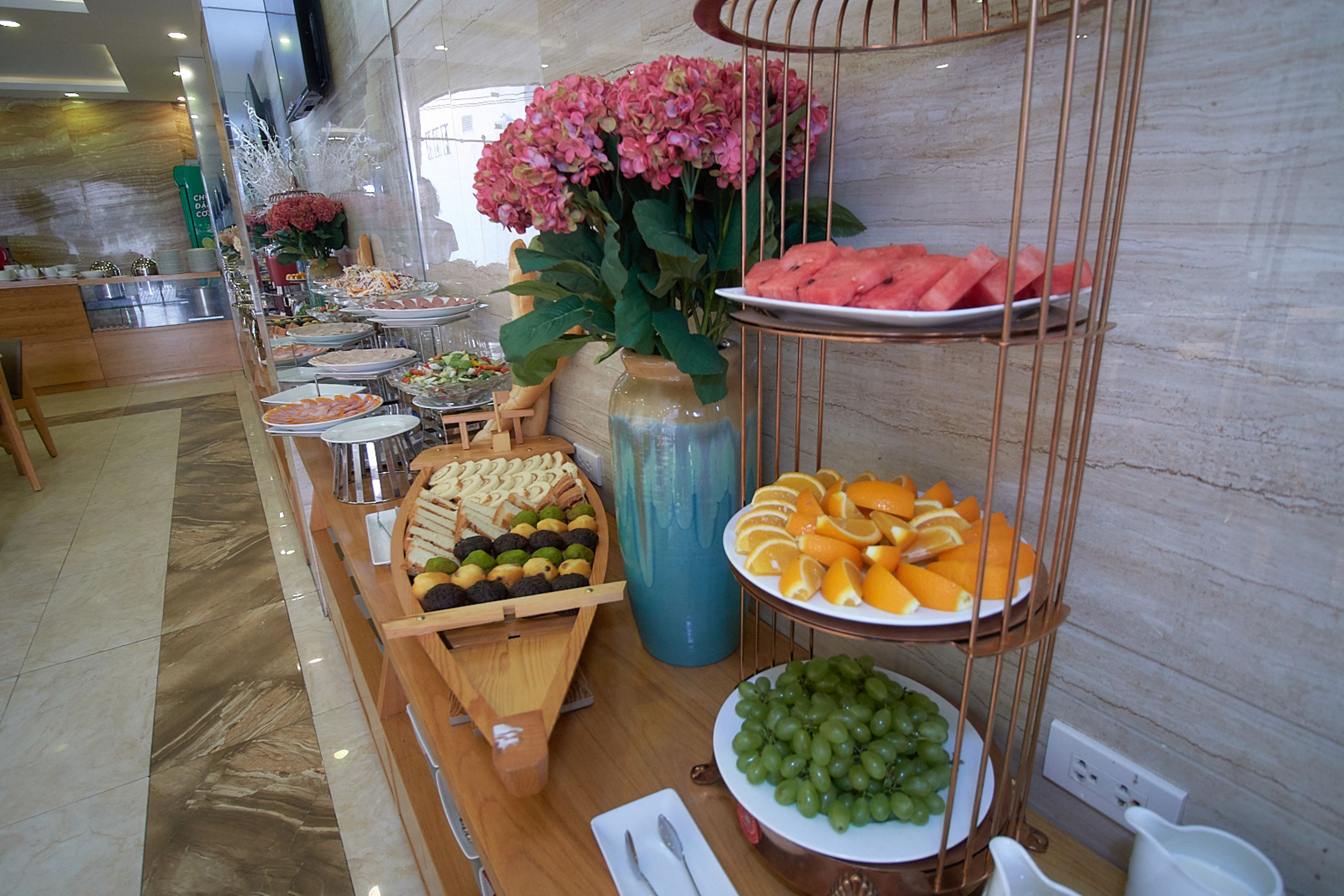 A buffet with various fruits and vegetables, including watermelon and grapes.