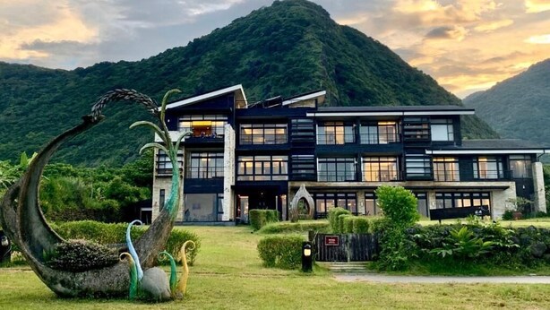 A modern hotel with a multi-story structure, large windows, and a well-maintained lawn in front. - Adagio Shitiping (Fengbin)