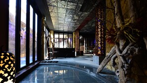 A spacious lobby with a reflective floor, large windows, and a decorative wall. - Hakone Airu (Hakone)