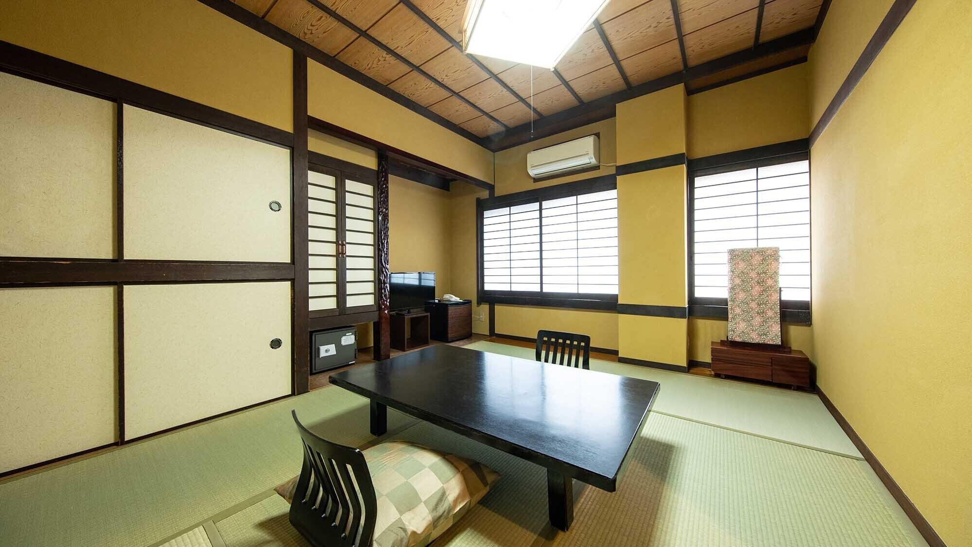 A traditional Japanese room with tatami flooring, a low table, and shoji screens.