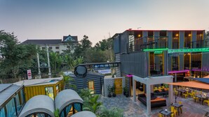 A modern building with a rooftop bar, outdoor seating, and a mix of indoor and outdoor spaces. - White Rabbit Hostel - Adults Only (Siem Reap)