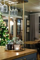 Una encimera de cocina con un tarro de vidrio, una olla de metal y un candelabro de vidrio.