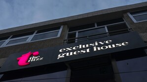 A building with a sign that reads "The Ritz exclusive guest house." - The Ritzz Exclusive Guest House (Accra)