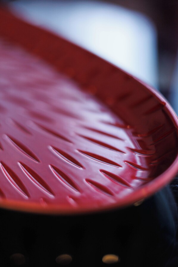 A close-up of a red plastic basket with slits. - The Ritzz Exclusive Guest House (Accra)