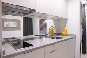 Full-size fridge, microwave, stovetop, coffee/tea maker