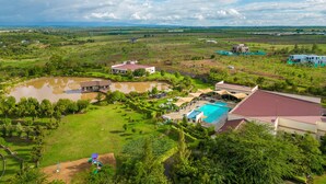 A large estate with a swimming pool, tennis court, and expansive green lawns. - Maiyan Luxury Resort (Nanyuki)