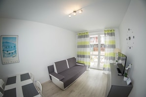 Apartment (Baltycki) | Living area | Flat-screen TV - Sun&Relax Apartamenty Bursztynowe (Kolobrzeg)