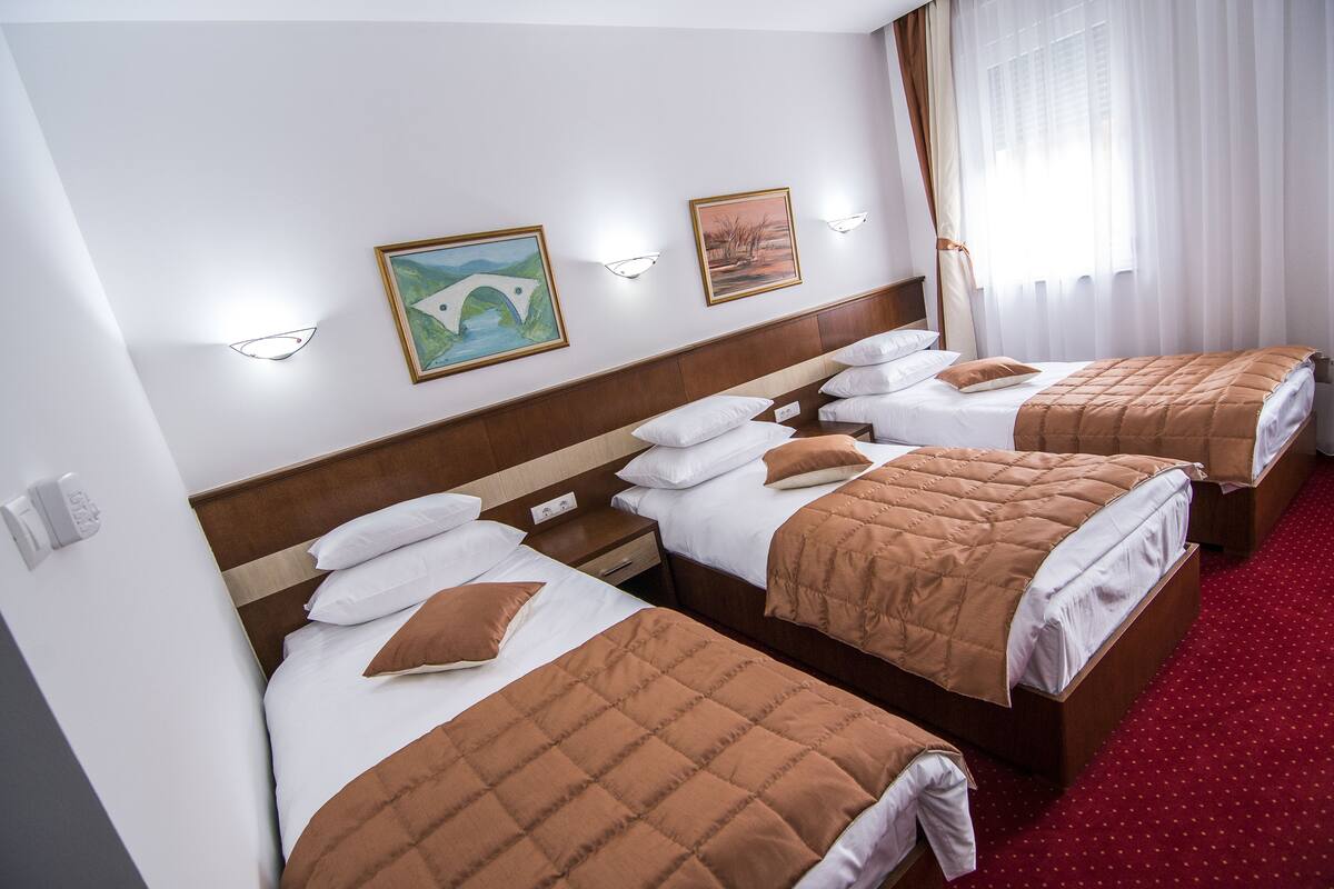Triple Room | Minibar (free items), in-room safe, desk, soundproofing
