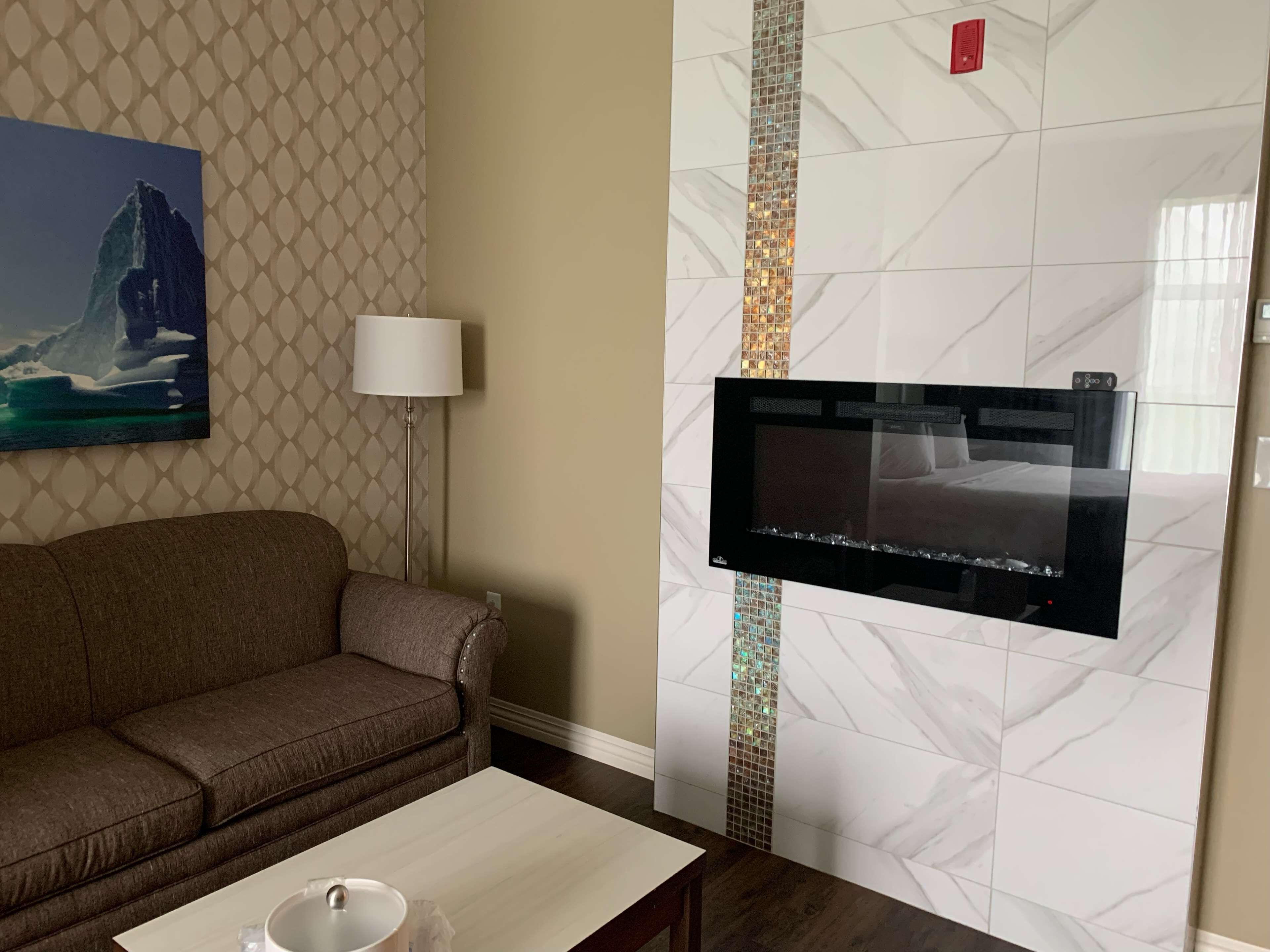 suite, 1 king bed, non smoking, fireplace | in-room safe, desk, blackout curtains, soundproofing